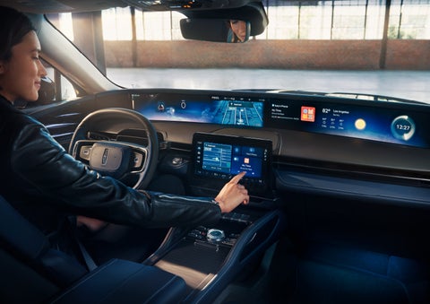 The driver of a 2024 Lincoln Nautilus® SUV interacts with the center touchscreen. | Beck Lincoln in Palatka FL
